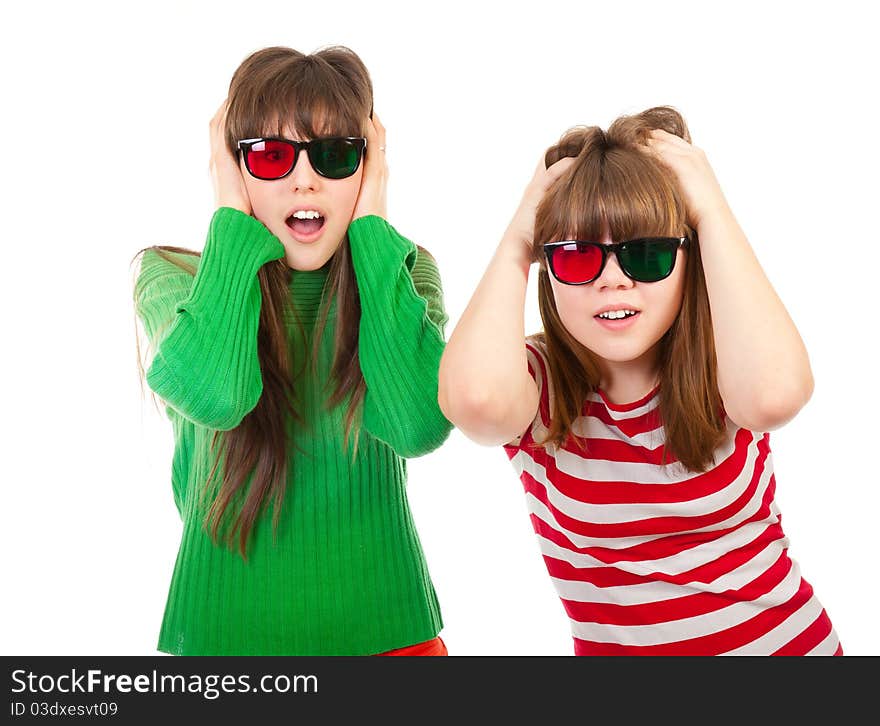 Sisters having fun while watching 3D movie isolated on white background