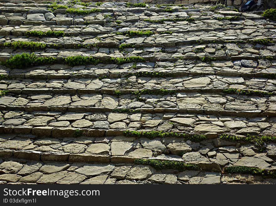 Stone steps with grass at Methoni Castle at late summer sun. Stone steps with grass at Methoni Castle at late summer sun.