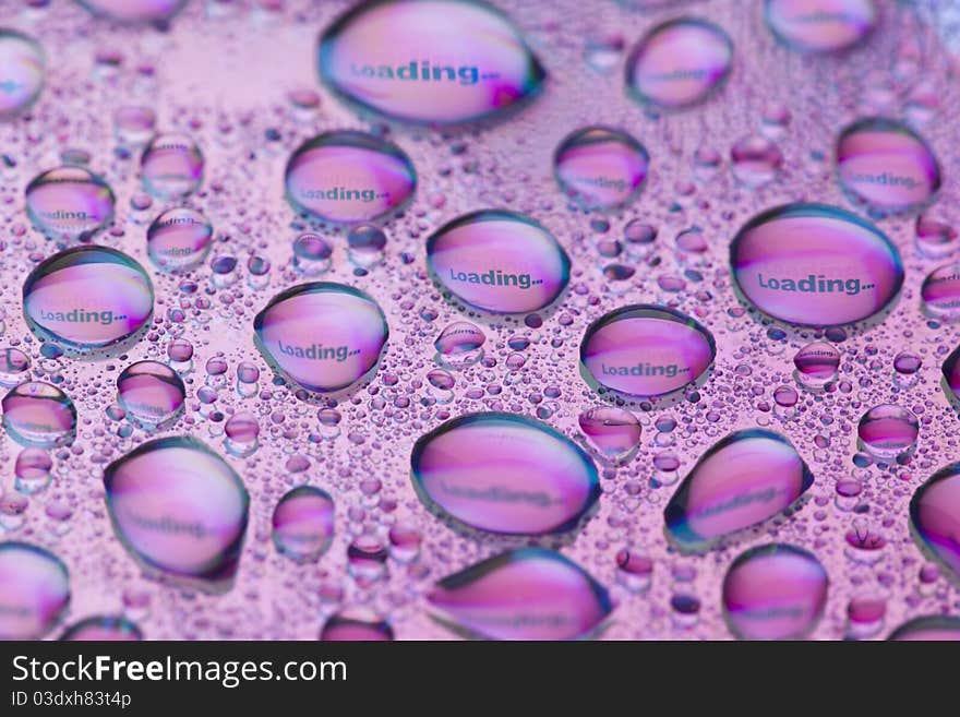 The word Loading... in water drops. Close-up of studo shot.