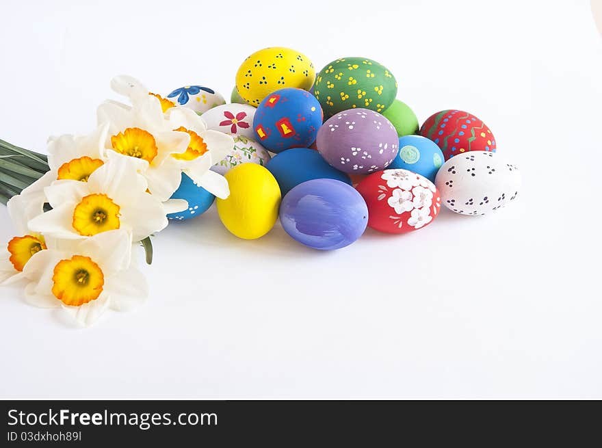 Painted easter eggs with various decoration photographed on white background with Narcissus. Painted easter eggs with various decoration photographed on white background with Narcissus