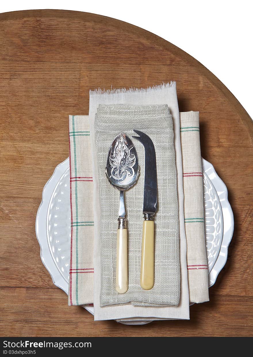 Old spoon and fork on antique linen and plate. Old spoon and fork on antique linen and plate