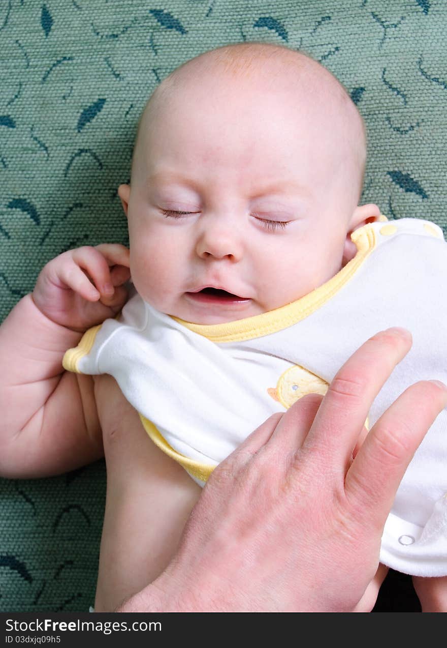 Father dressing cute baby up