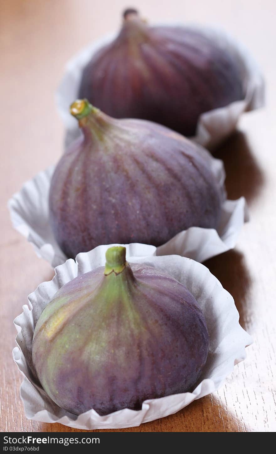 The fresh figs on the wooden background. The fresh figs on the wooden background