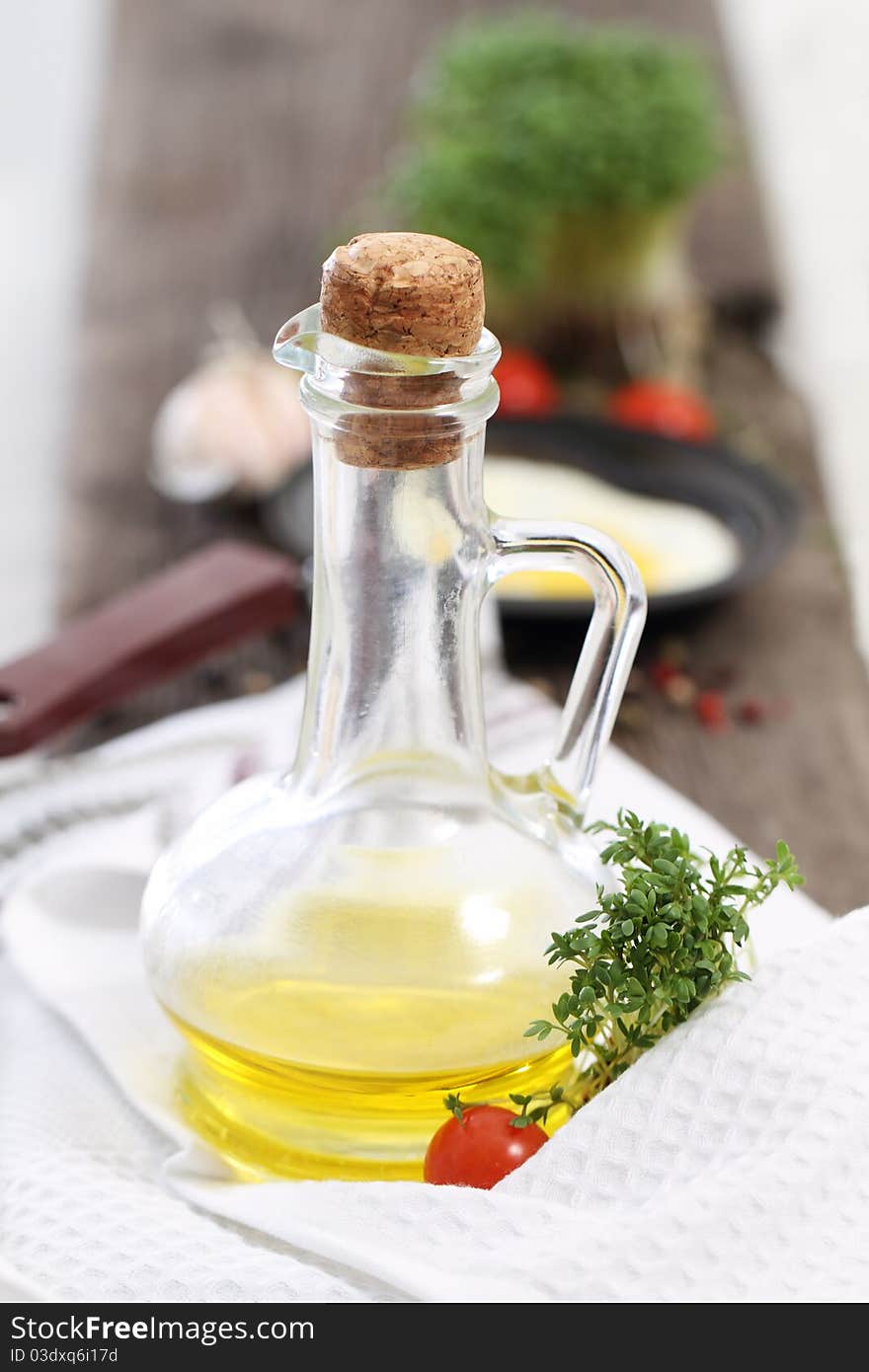 Bottle of the olive oil with tomato and cress. Bottle of the olive oil with tomato and cress