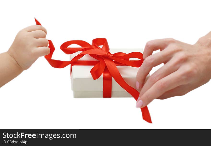 Child and woman hands opening the present