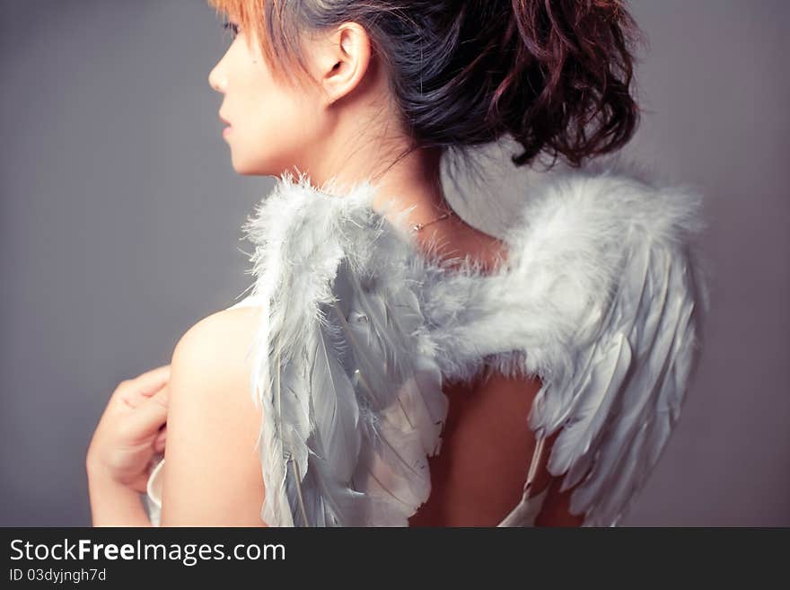 Girl wearing a white top with wings. Girl wearing a white top with wings.