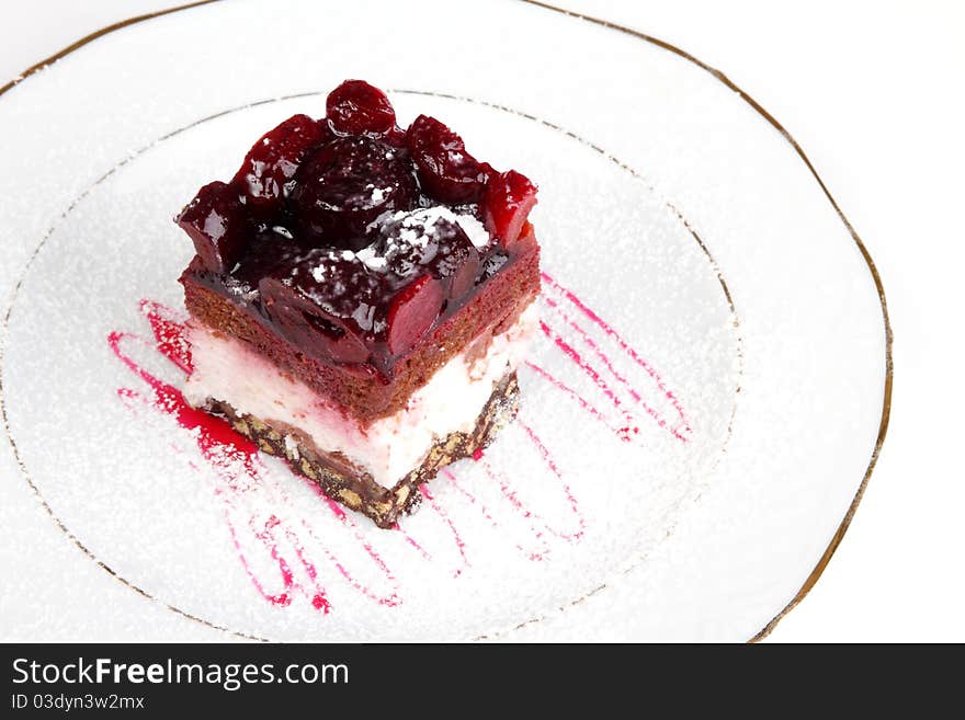 Slice of a biscuit pie with a cherry on a white plate