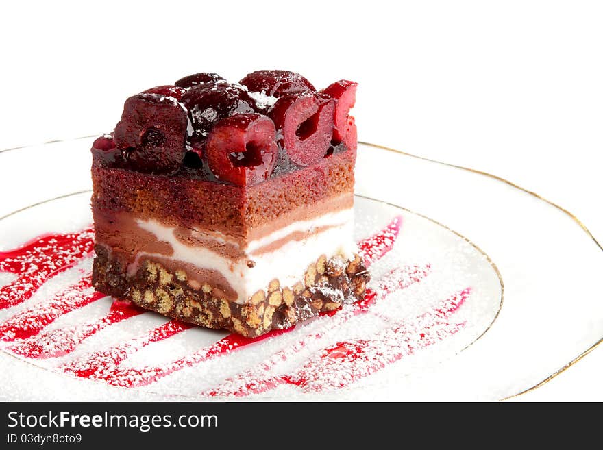 Slice of a biscuit pie with a cherry on a white plate