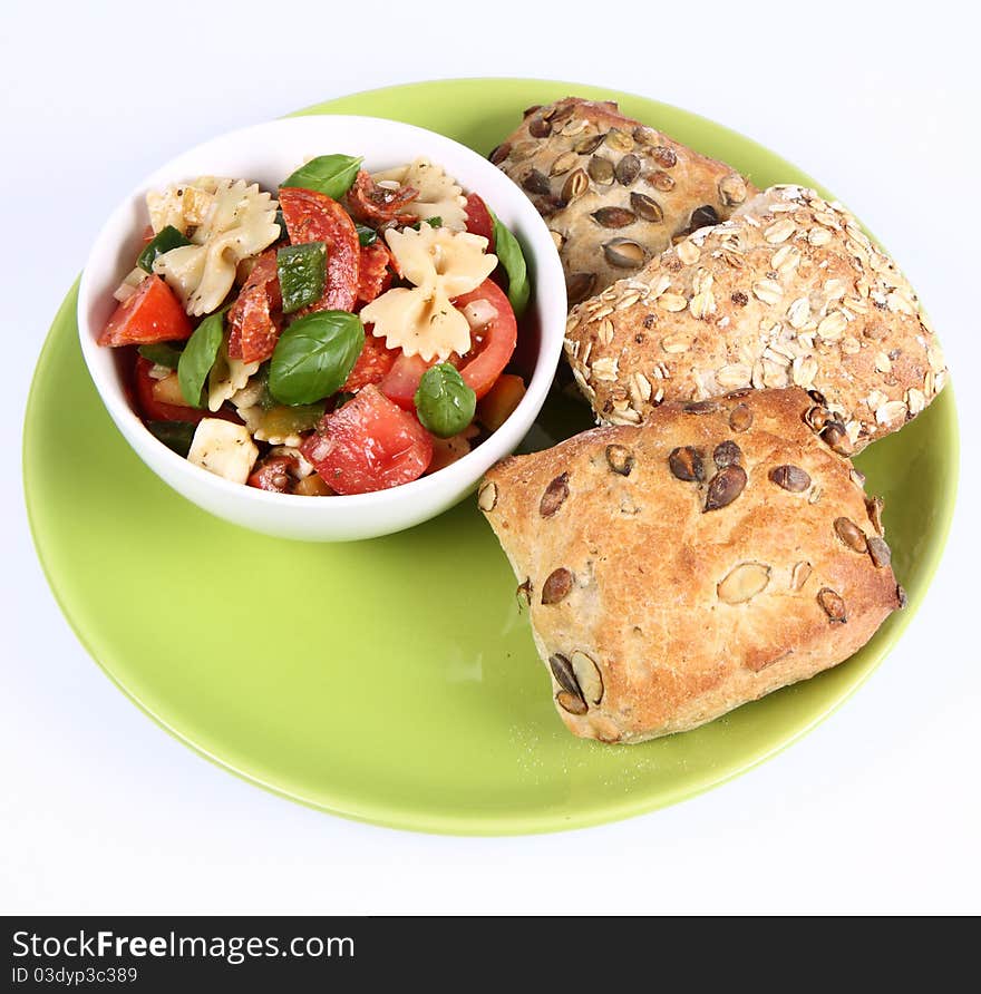 Salad - made of farfalle pasta, tomato, salami, bell pepper, mozzarella, basil, with three rolls. Salad - made of farfalle pasta, tomato, salami, bell pepper, mozzarella, basil, with three rolls