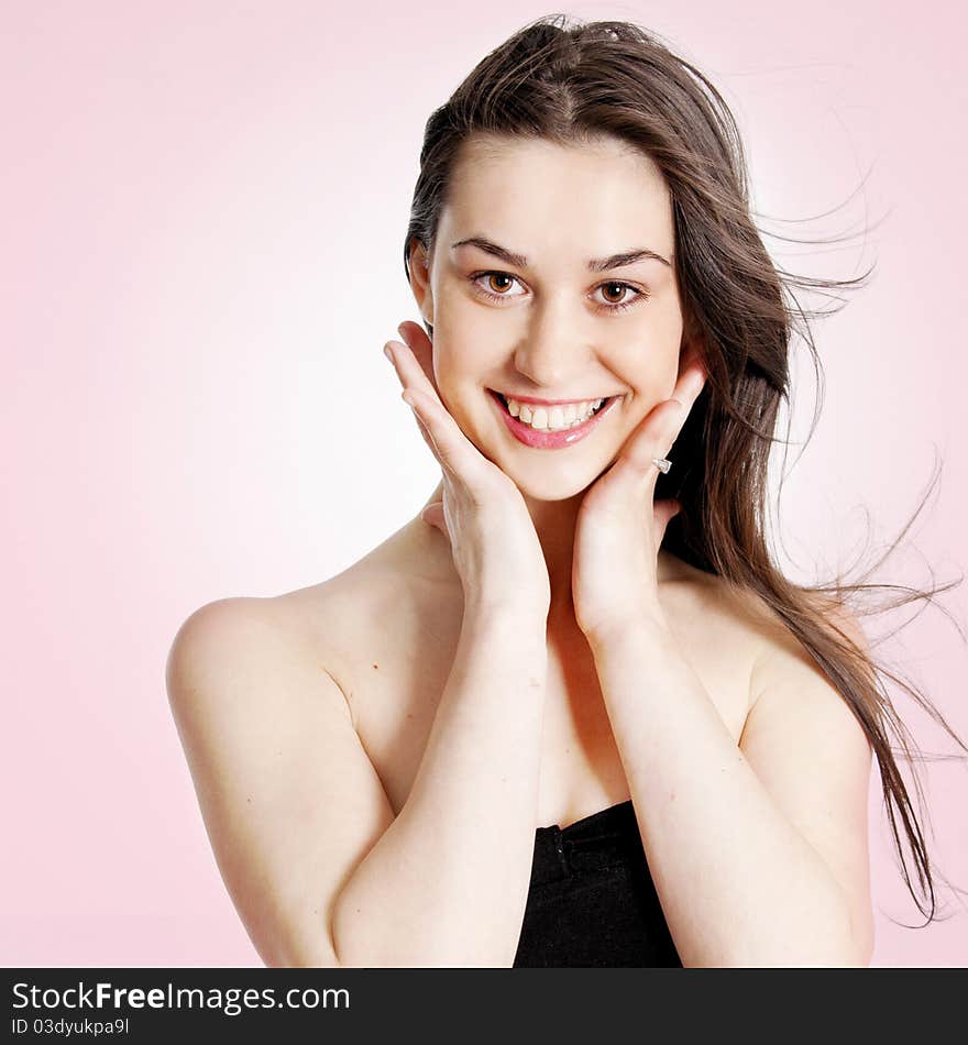 Portrait of a beautiful girl over pink background