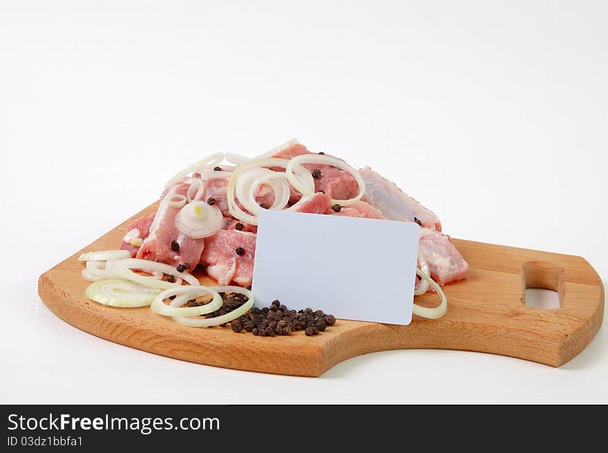 Raw meat, spices and plastic card on wood board. Raw meat, spices and plastic card on wood board