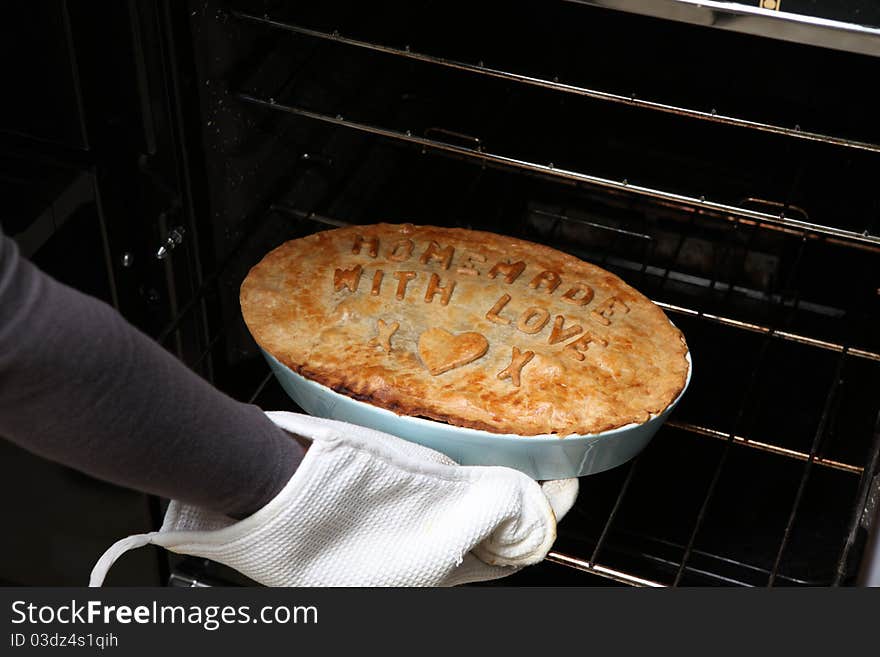 A home made pie with letters on. A home made pie with letters on.