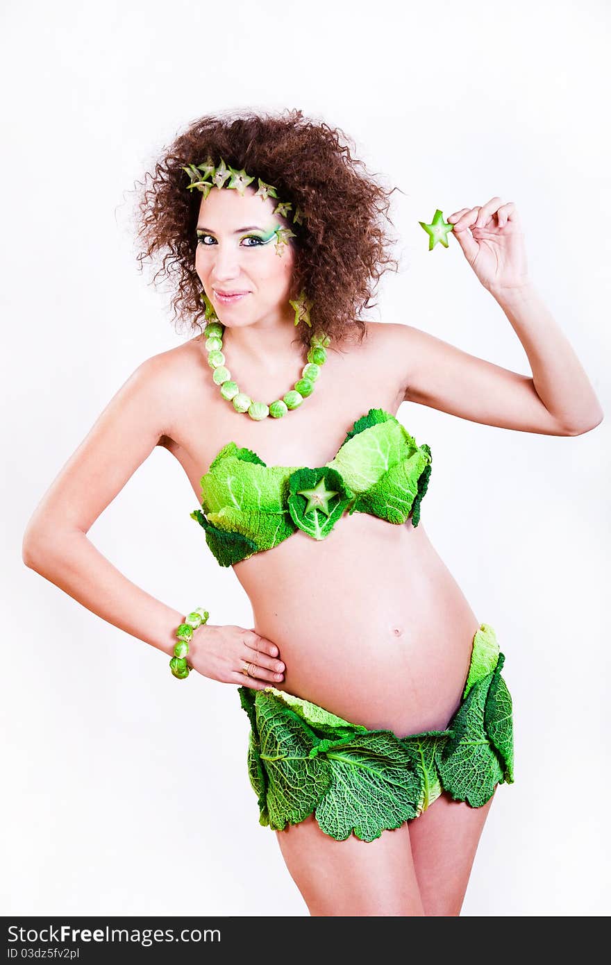 Beautiful pregnant young woman dressed in cabbage