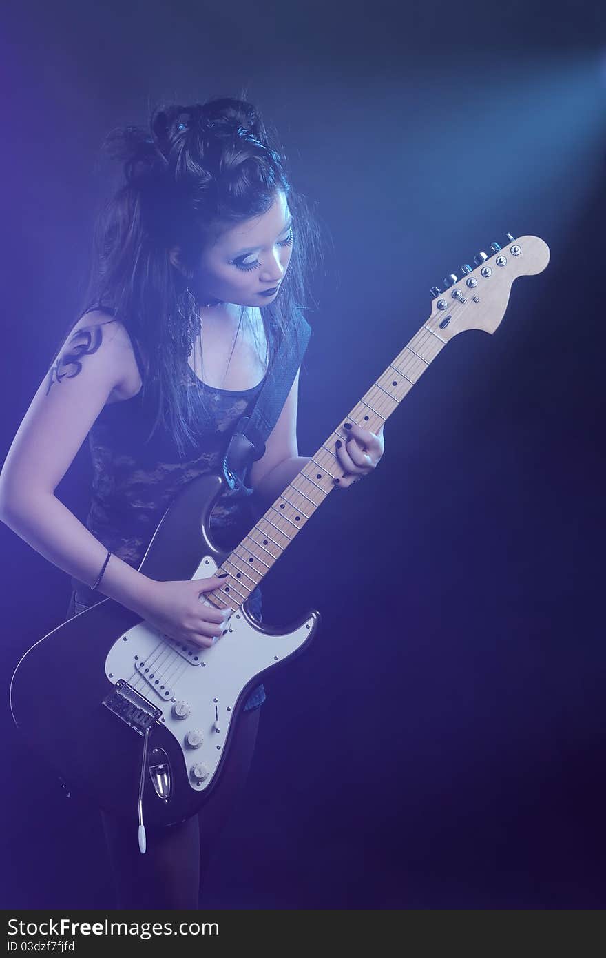 Woman rock star portrait with guitar