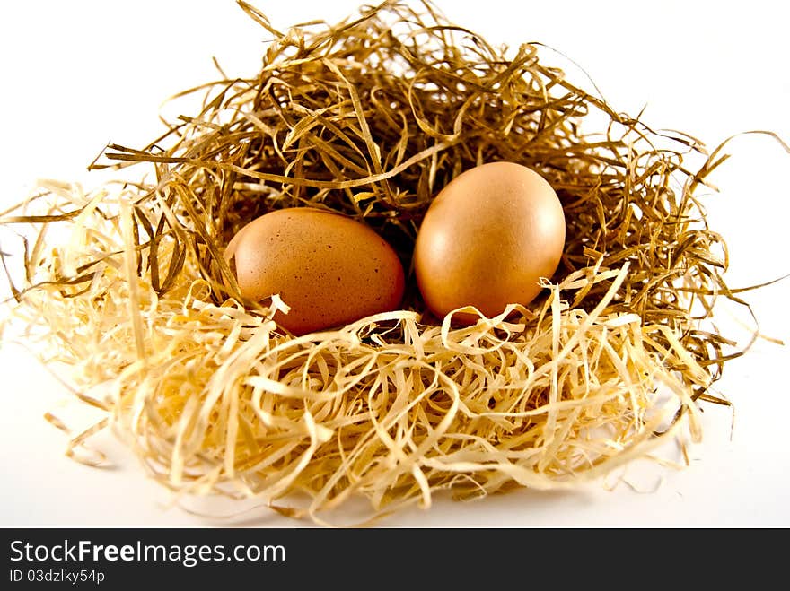 Two eggs lying on the straw of which may appear chickens