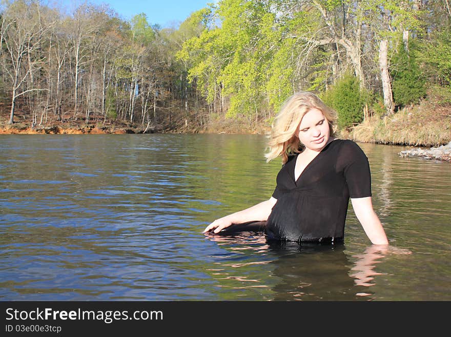 Beautiful pregnant woman standing in the lake. Beautiful pregnant woman standing in the lake.