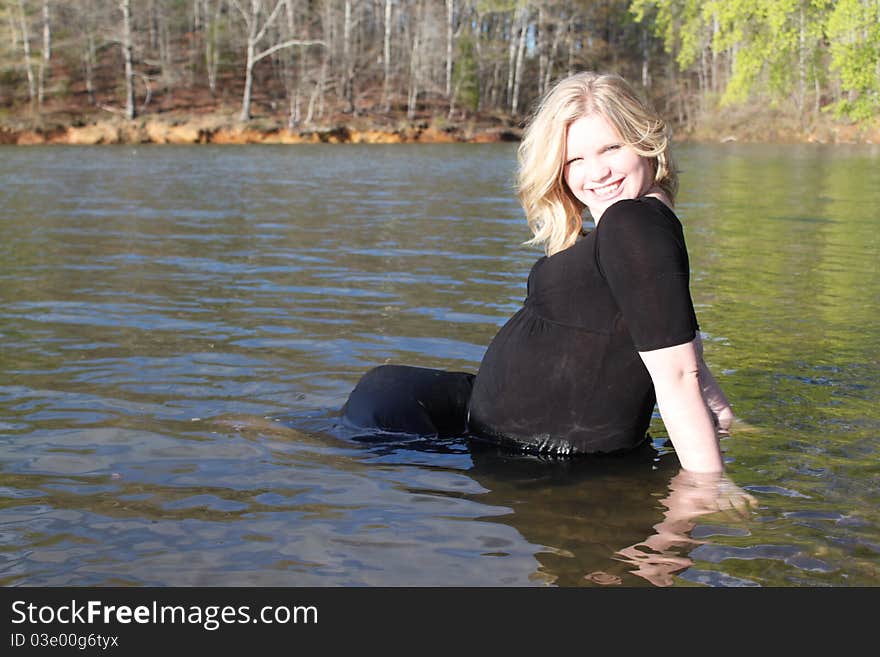 Beautiful pregnant water sitting in the water in a natural setting. Beautiful pregnant water sitting in the water in a natural setting.