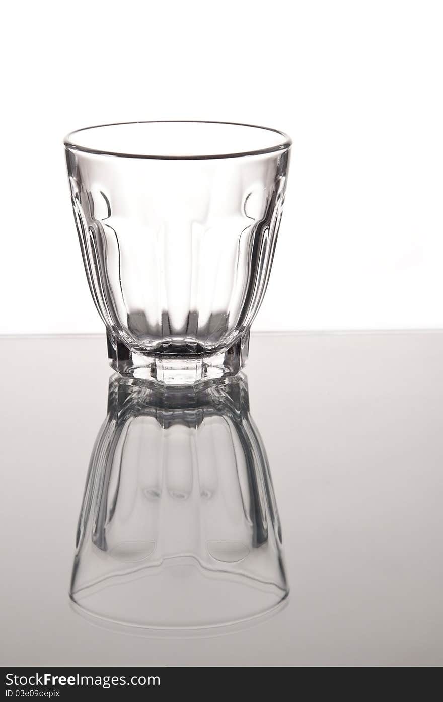 Empty small whisky glass with mirror reflaction