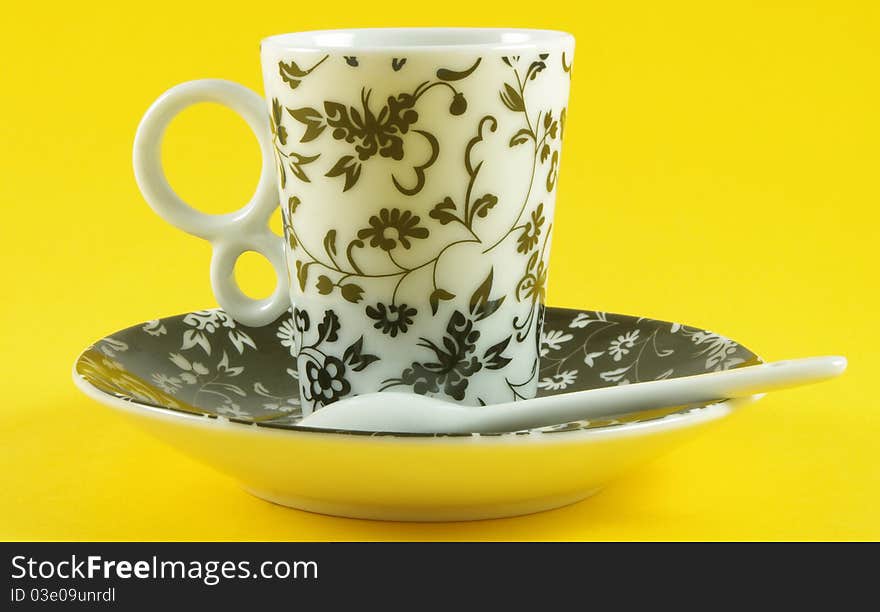 Cup and saucer isolated over yellow background. Cup and saucer isolated over yellow background