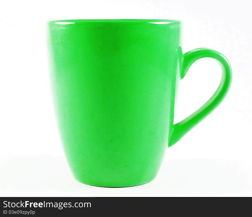 Old green mug isolated on white surface