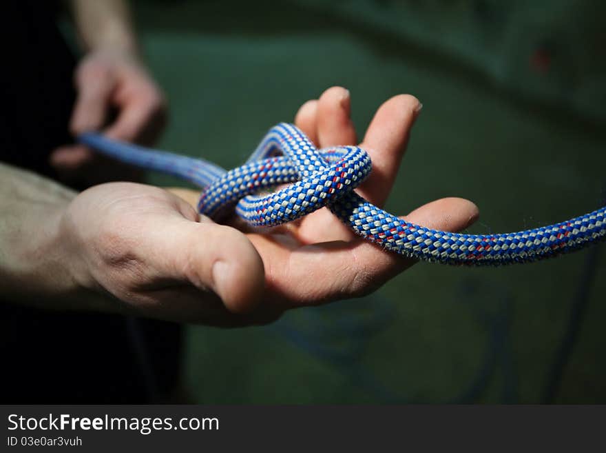 Hands holding and tying rope. Hands holding and tying rope