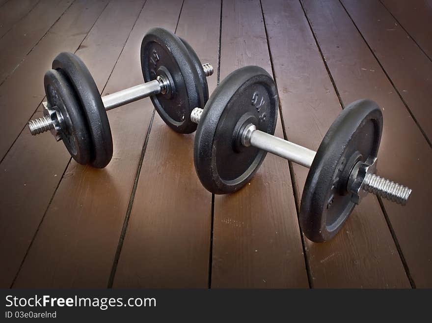 Two dumbbells set on vintage floor