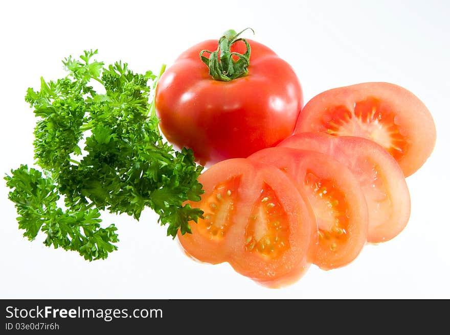 A sliced juice tomato on a white background. A sliced juice tomato on a white background