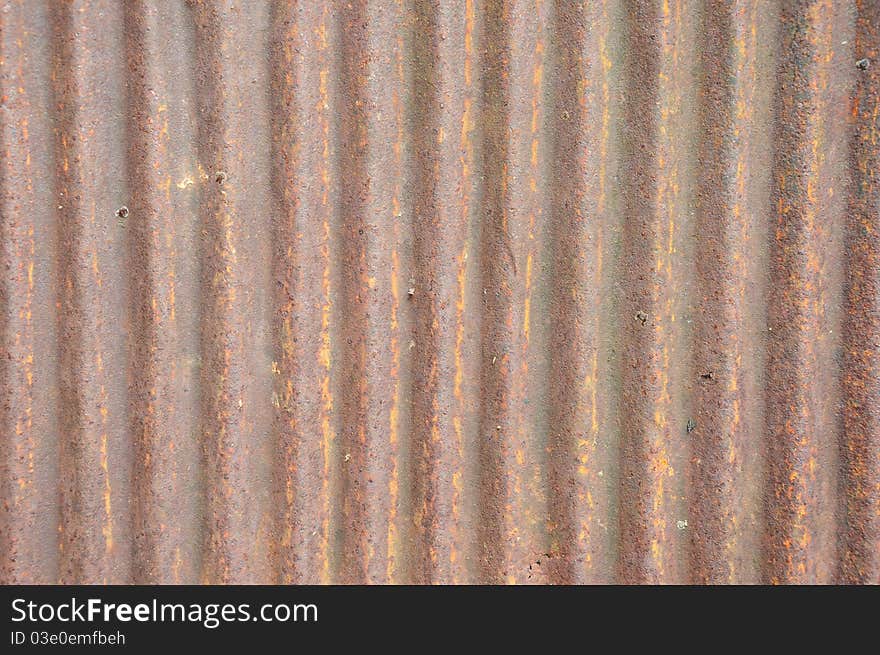 A piece of an old brown zinc background texture. A piece of an old brown zinc background texture