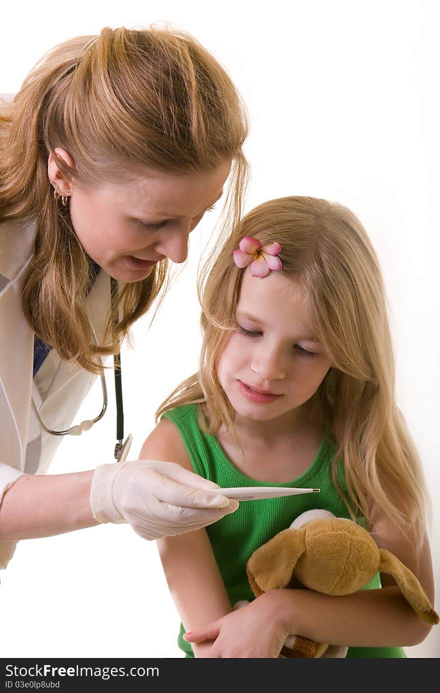 Lady doctor and eight year old girl both looking at a thermometer on white background. Lady doctor and eight year old girl both looking at a thermometer on white background