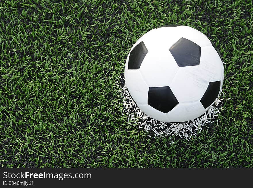 Close up of soccer ball on the center of soccer field