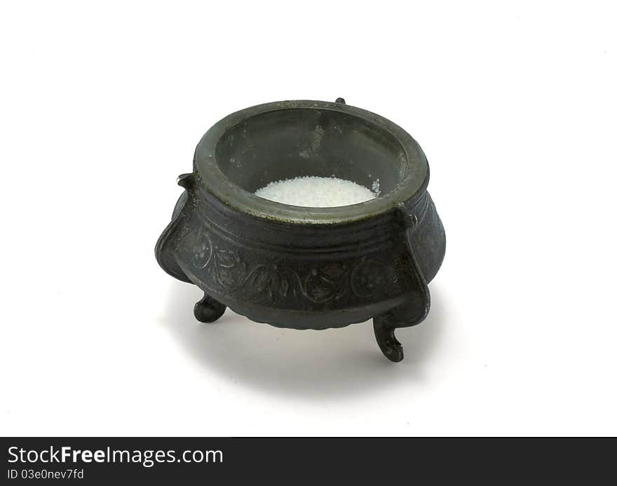 Antique bronze saltcellar on the legs and salt. Antique bronze saltcellar on the legs and salt