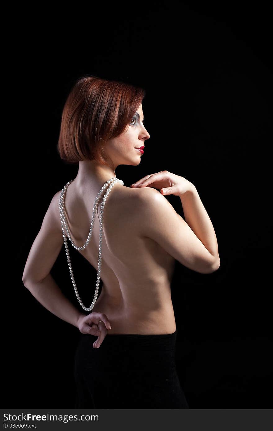 Woman with naked spine and pearl beads