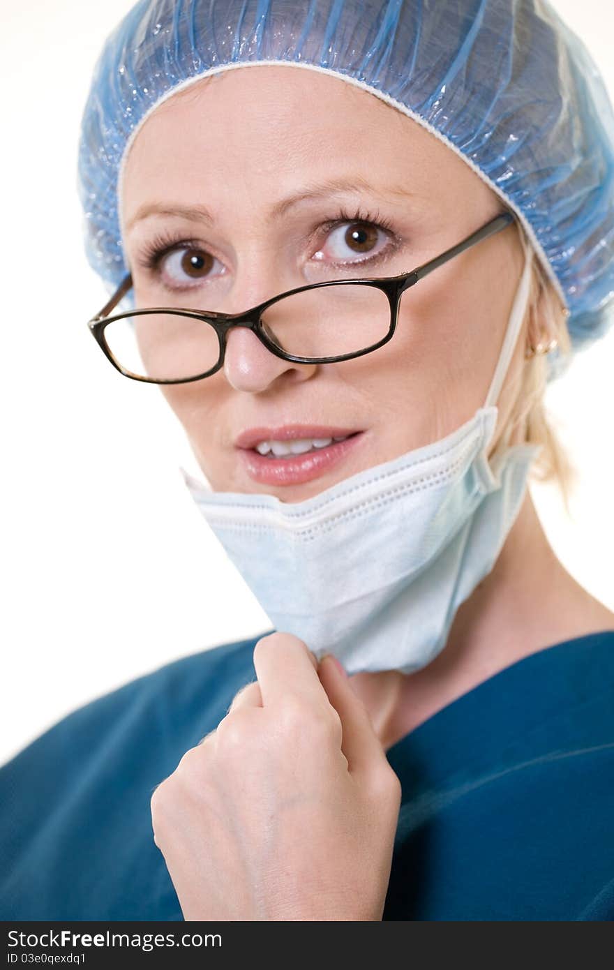 Face of a caucasian woman doctor wearing protective hair net and face mask wearing dark glasses. Face of a caucasian woman doctor wearing protective hair net and face mask wearing dark glasses