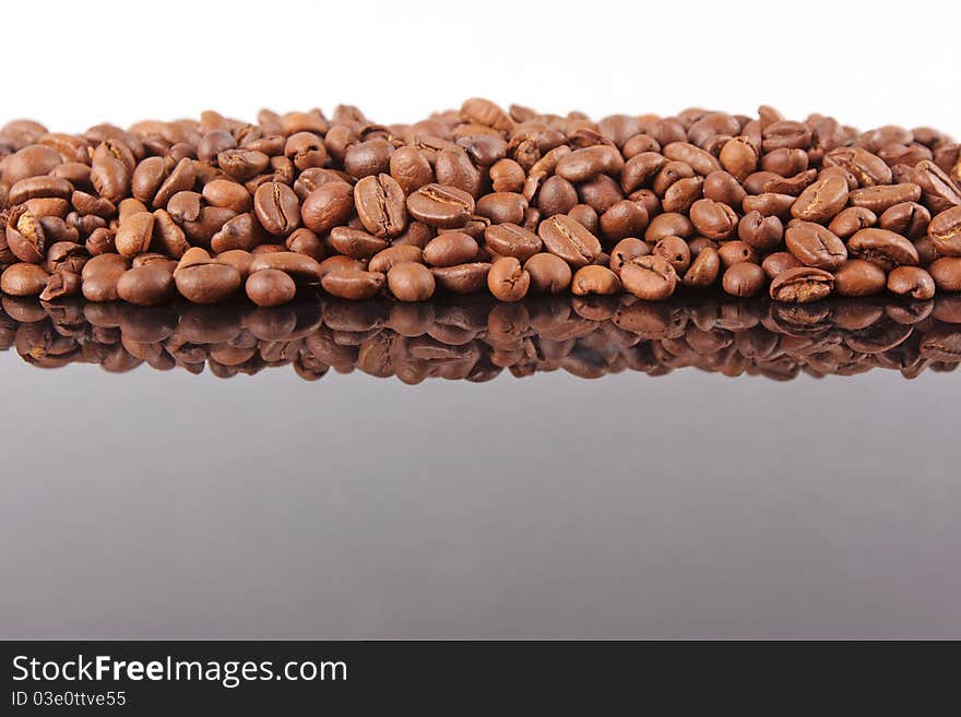 Coffee Beans background, reflected on black glass