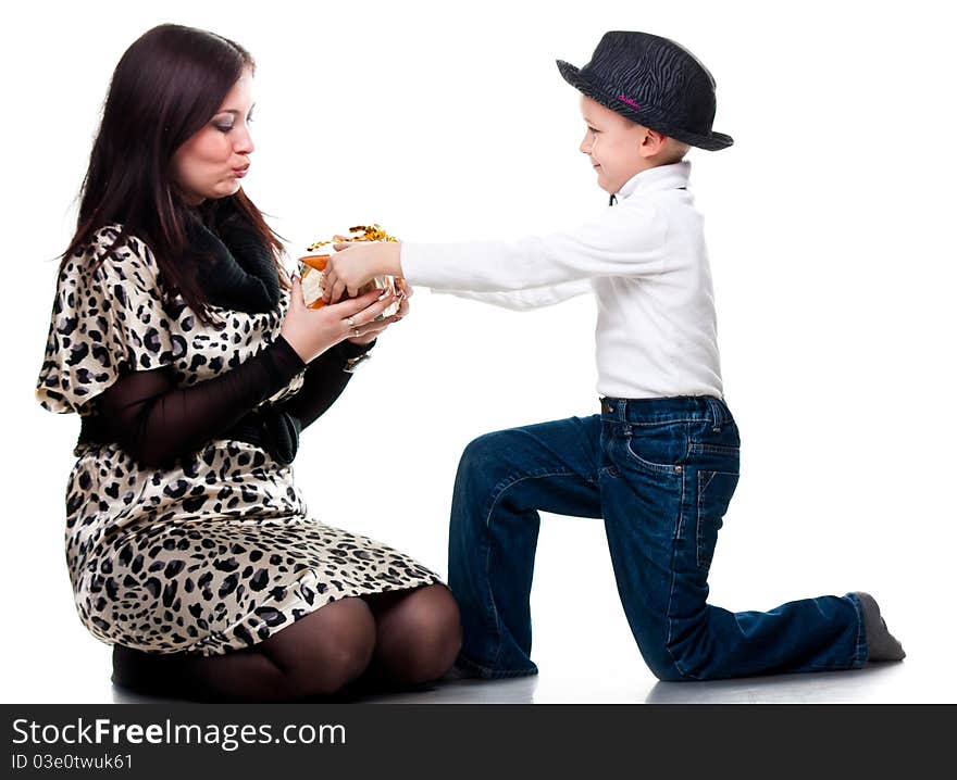 Cute boy giving a present to his mother isolated on white