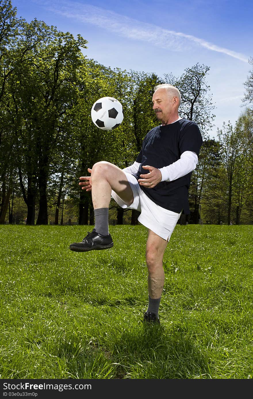 Senior football player in the park