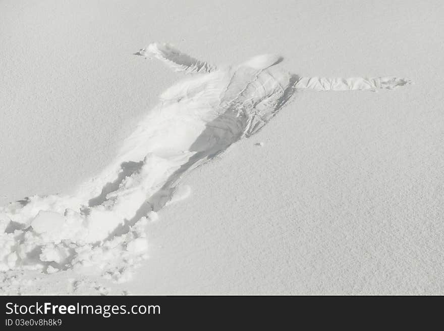 Beautiful snow angel made in total relaxation, in deep snow, greeting winter