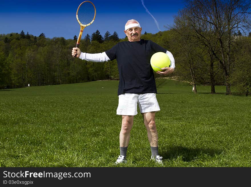 Senior man playing tennis