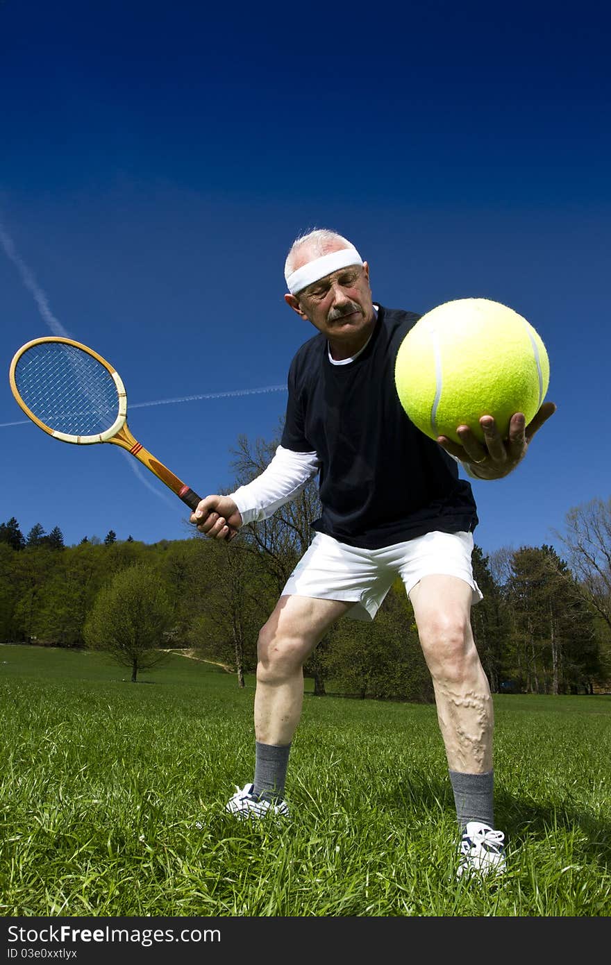 Senior man playing tennis