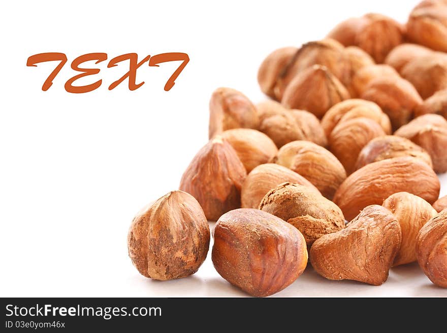 Brown shelled hazelnuts isolated on white background