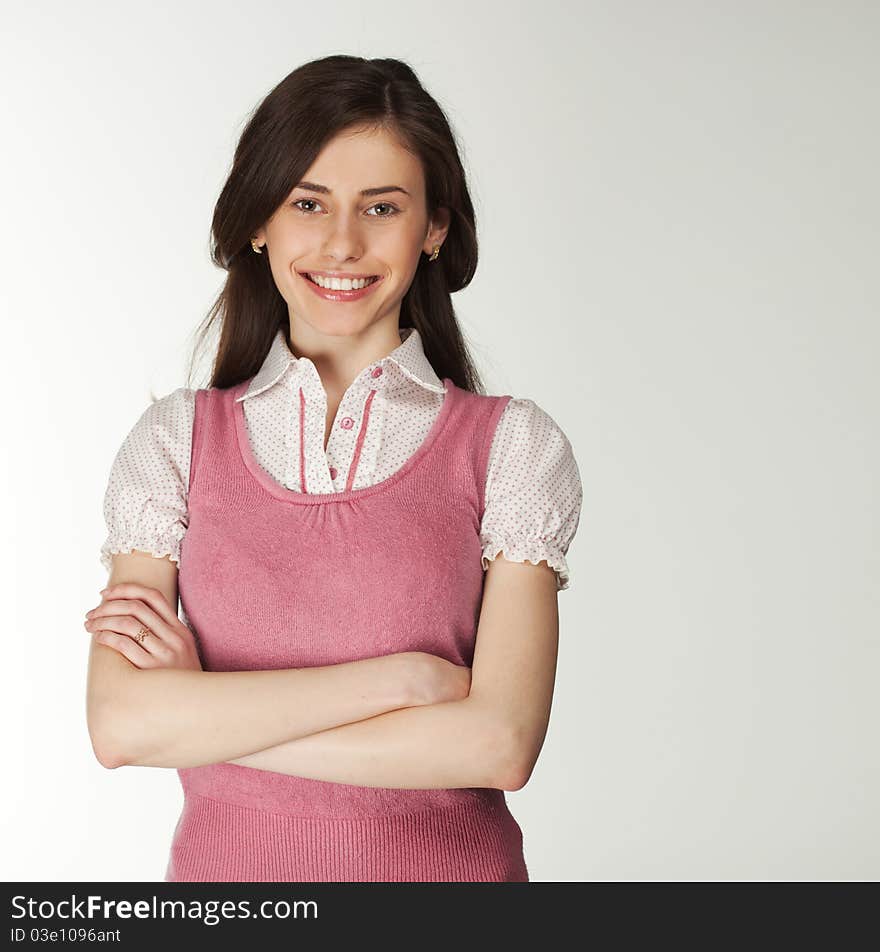 Smiling girl with text area on a grey background. Smiling girl with text area on a grey background