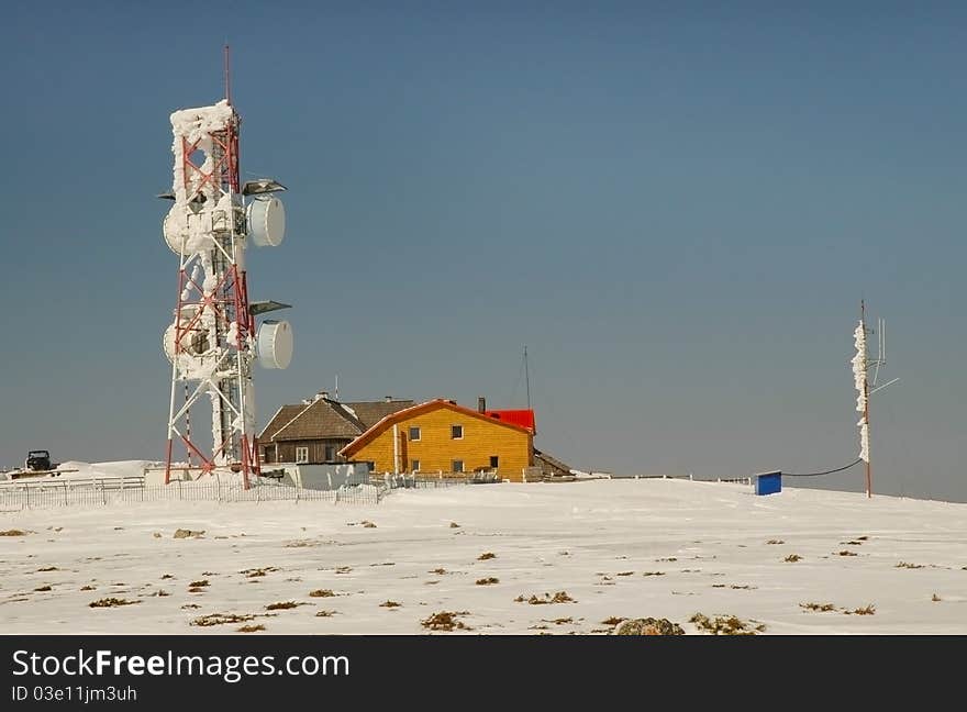 An ice-covered screen weather station, high on a mountain-top at Vladeasa, Romania. An ice-covered screen weather station, high on a mountain-top at Vladeasa, Romania