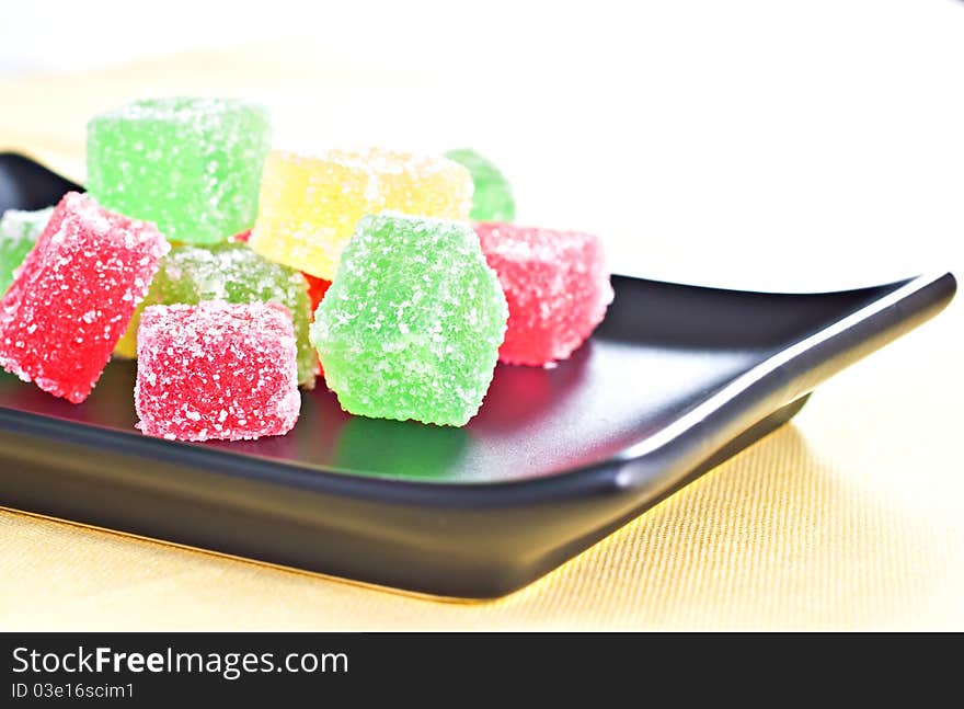 Marmalade candy on a dark plate. Marmalade candy on a dark plate.