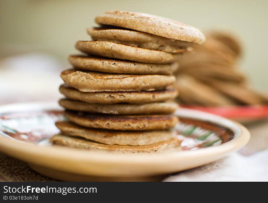 Stack of sweet oat pancakes on a ceramic plate. Stack of sweet oat pancakes on a ceramic plate