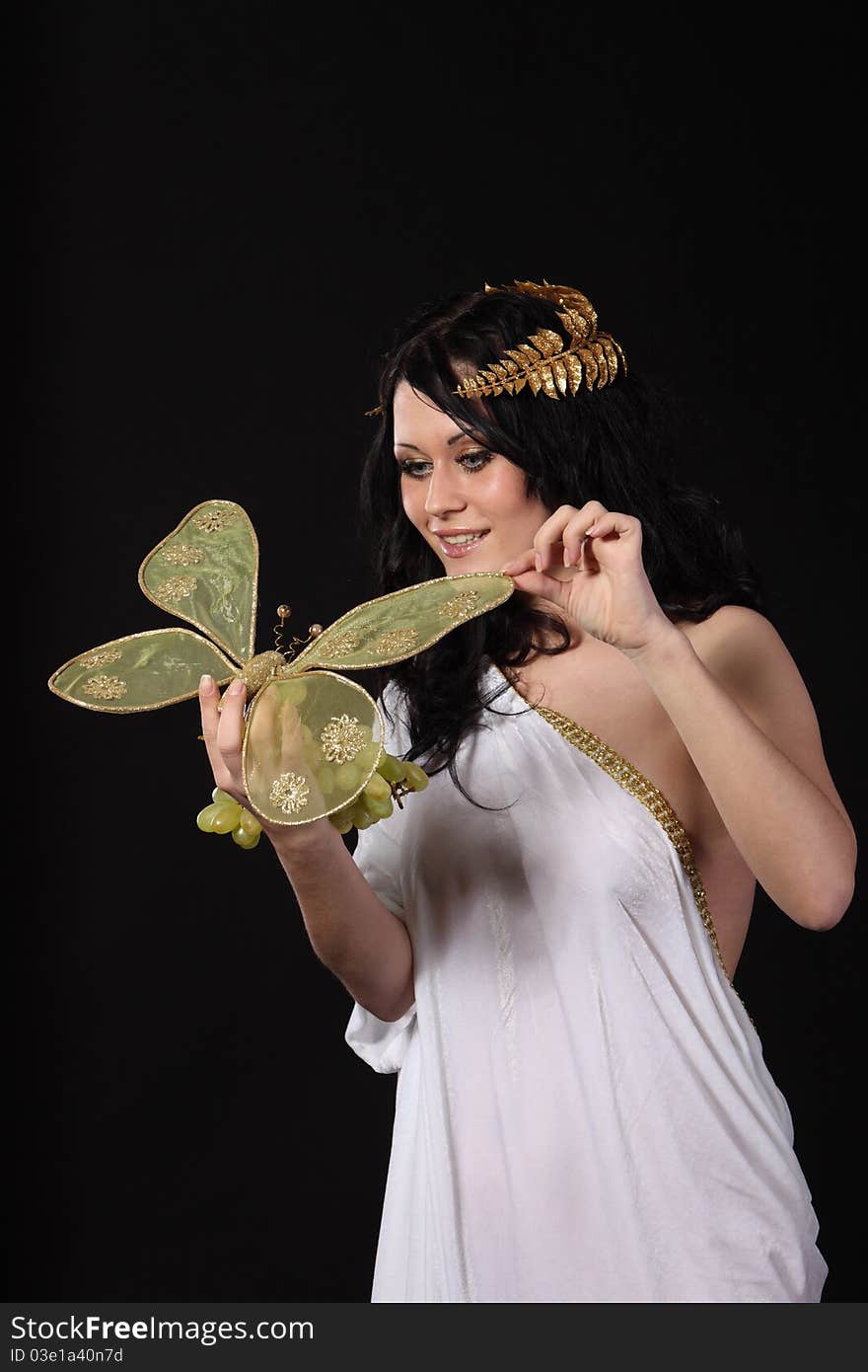 Woman with a bunch of grapes and a butterfly