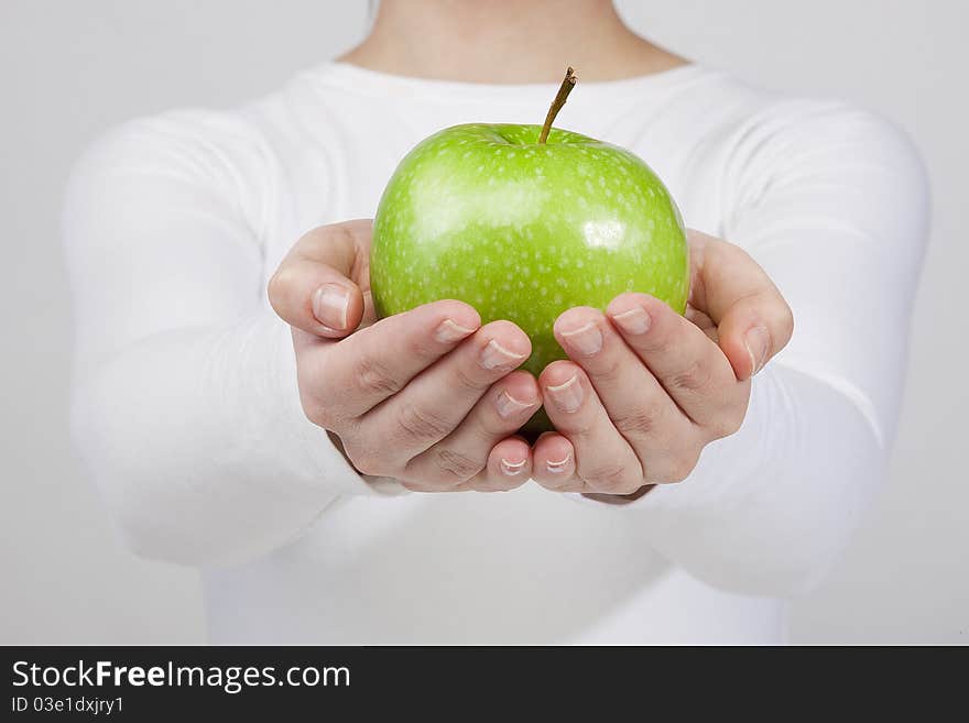 Woman holding green apple in her hands. isolated on white background. Woman holding green apple in her hands. isolated on white background