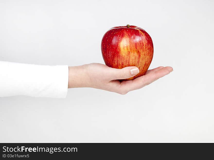 Healthy red apple in woman hand, isolated on white. Healthy red apple in woman hand, isolated on white