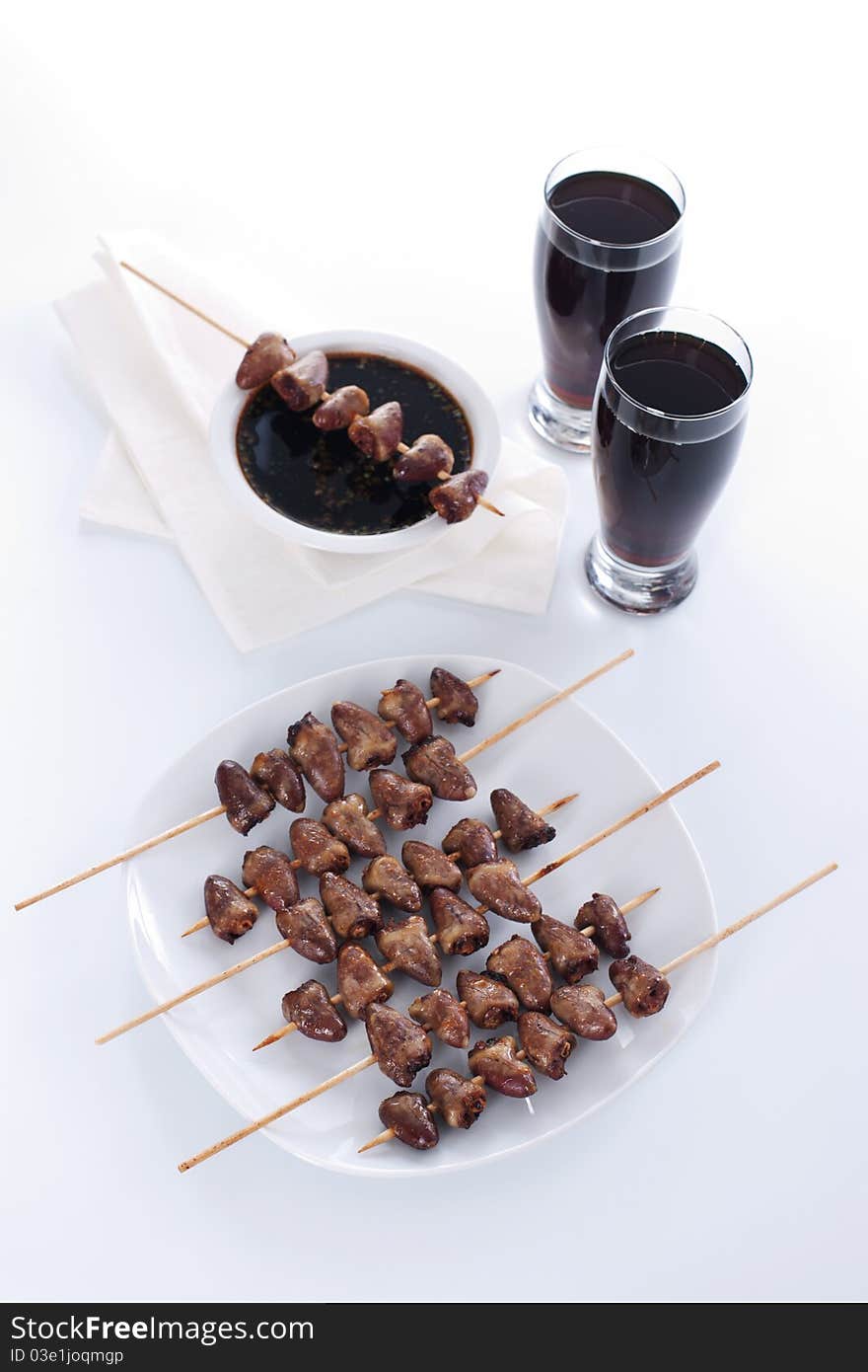 Grilled chicken hearts on skewers