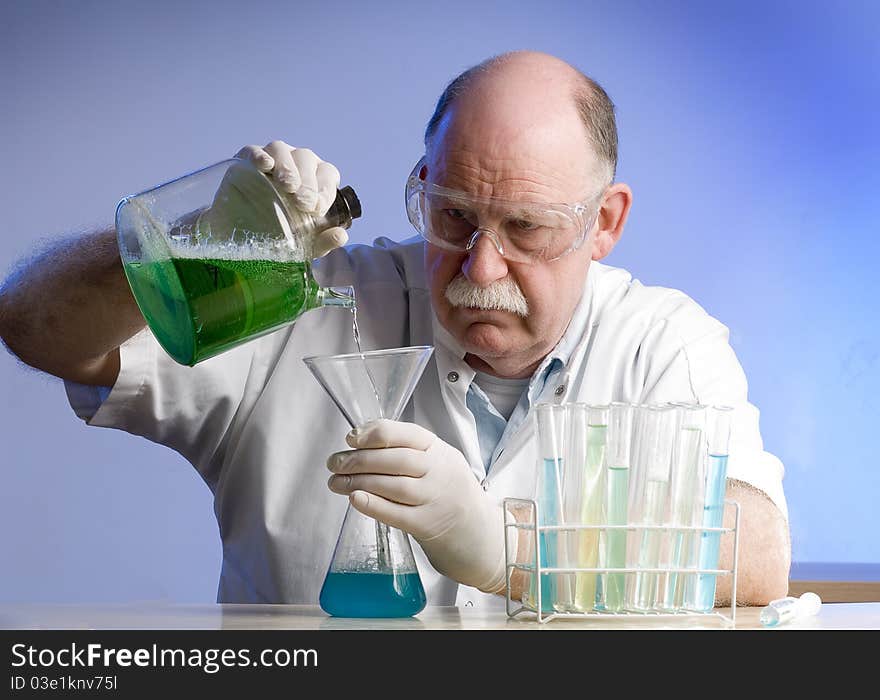 Scientist working with chemicals on blue background