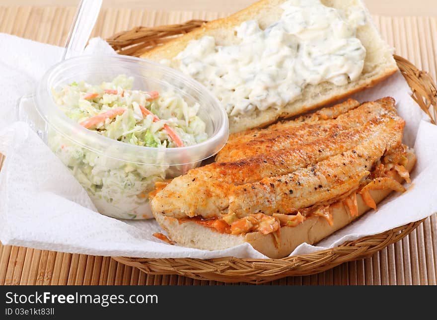 Catfish fillet sandwich with coleslaw in a basket